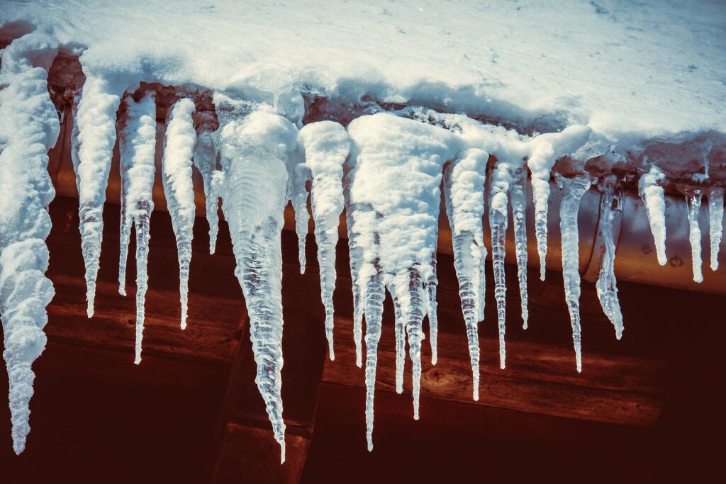 Ice damns and icicles forming on roof